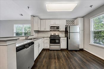 A kitchen with white cabinets